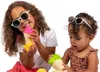 Two young children playing with toy ice cream cones. Voir les images du produit