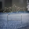 A lighted star decoration on a blue, textured surface, likely outdoors in low light. Produktbild-Vorschau