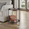 A side table next to a sofa in a living room. Produktbild-Vorschau