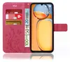 A pink flip phone case with a floral pattern, showing credit cards and euro banknotes inserted into the card slots, and a smartphone displayed within the case. Produktbild-Vorschau