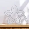 A decorative flower lamp is placed on a wooden shelf against a white wall. Produktbild-Vorschau