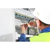 An electrician working on a control panel. Náhľad obrázku produktu