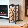 A black metal firewood rack filled with logs is placed next to a modern fireplace. Anteprima dell’immagine prodotto