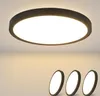 A close-up of a black LED ceiling light mounted on a white ceiling, with three smaller, similar lights shown in the foreground. Podgląd zdjęcia produktu