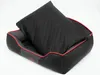 A black and gray dog bed with a black quilted pillow inside, set against a white background. Produktbild-Vorschau