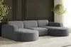 A modern U-shaped sectional sofa in a dark gray corduroy fabric, placed in a stylish living room with dark paneled walls and a potted plant. Produktbild-Vorschau