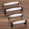A set of cabinet handles on a wooden surface. Produktbild-Vorschau