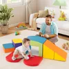 A father and baby playing with colorful foam blocks in a living room. Produktbild-Vorschau