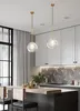 A modern kitchen with pendant lights over a breakfast bar. Anteprima dell’immagine prodotto