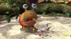 A creature from the Pikmin video game series is being attacked by small Pikmin creatures. Produktbild-Vorschau