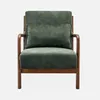 A green armchair with a wooden frame against a light gray background. Produktbild-Vorschau