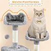 A cat sitting on a cat tree with text overlays. Podgląd zdjęcia produktu
