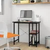 A black computer desk with a monitor, books, and a chair in a room. Podgląd zdjęcia produktu
