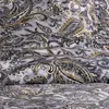 A close-up view of a fabric with a paisley pattern. Produktbild-Vorschau