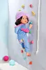 A doll is climbing a rock wall with colorful holds. Produktbild-Vorschau