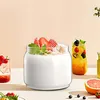 Close-up of yogurt with strawberries and granola in a glass jar, with other fruit drinks in the background. Produktbild-Vorschau
