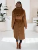 A woman wearing a brown winter coat stands with her back to the camera. Náhled obrázku produktu