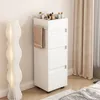 A white bathroom cabinet with drawers and a towel rack, placed next to a floor lamp and curtains. Produktbild-Vorschau