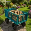 A teal garden cart filled with logs sits on a stone path in a garden with blooming flowers and green grass. Voir les images du produit