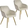 Two cream-colored chairs with gold legs against a white background.