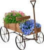 A wooden wagon filled with pink and blue flowers, set against a white background. Produktbild-Vorschau