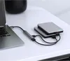 A laptop connected to a USB hub which is then connected to two external hard drives, all placed on a white desk. Náhled obrázku produktu