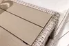A close-up view of the corner of a garden bench with a woven rattan frame and wooden slats. Produktbild-Vorschau