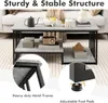 A coffee table with a marble-like finish and black metal frame, shown in a living room setting with decorative items on it. Produktbild-Vorschau