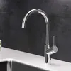 A modern kitchen faucet with a high arc and a single lever handle, installed on a white countertop with a dark tiled backsplash. Produktbild-Vorschau