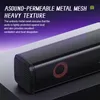 Close-up of a black soundbar with a metal mesh grille, featuring a red circular accent. Text overlays describe its features. Náhled obrázku produktu