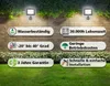 Two outdoor LED spotlights are mounted on a brick wall above a garden bed. Produktbild-Vorschau