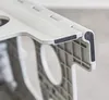 A close-up, slightly angled shot of a gray and white plastic step stool. The focus is on the joint where the top step meets the support structure, revealing the textured underside of the top step and the interlocking mechanism. Two black rubber anti-slip p Náhľad obrázku produktu