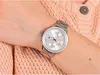 A close-up shot of a woman's wrist wearing a silver Tommy Hilfiger watch, with a pink knitted sweater in the background. Anteprima dell’immagine prodotto