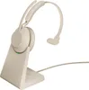 A beige Jabra Evolve2 65 UC Mono headset is shown on its charging base against a white background. Produktbild-Vorschau