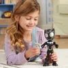 A young girl is playing with a Black Panther action figure on the floor. Produktbild-Vorschau