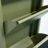 Close-up view of the interior of a green metal shoe cabinet with two open shelves. Anteprima dell’immagine prodotto