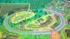 A colorful, illustrated overhead view of a board game or toy set depicting a train track winding through a village and surrounding countryside. Produktbild-Vorschau