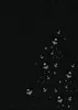 A close-up view of a black textured surface with water droplets. Voir les images du produit