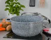A speckled gray pot with a glass lid sits on a black induction stovetop, with potatoes and carrots in the background. Náhľad obrázku produktu