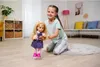 A young girl is playing with a doll in a living room. Anteprima dell’immagine prodotto