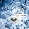 An Apple AirTag in a transparent holder with a silver keyring, surrounded by splashing water. Produktbild-Vorschau