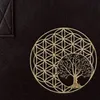 A close-up of a black bag with a golden embroidered design of the Flower of Life and a tree. Produktbild-Vorschau