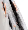 Close-up view of the interior of a gray tote bag with copper-colored zipper pulls and frame elements. Podgląd zdjęcia produktu