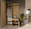 A hallway cabinet with a coat, shoes, and a plant in a modern interior. Náhled obrázku produktu