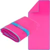A folded and an unfolded pink microfiber towel with blue trim and a blue elastic band. Produktbild-Vorschau