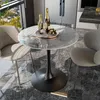 A round marble-top table with two chairs in a modern kitchen setting. Produktbild-Vorschau