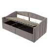 A gray upholstered daybed with its mattress support frame lifted to reveal storage compartments underneath. Anteprima dell’immagine prodotto