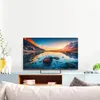 A modern living room setup with a TV on a cabinet, featuring a scenic landscape on the screen. Produktbild-Vorschau