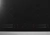A close-up, top-down view of a black induction cooktop. Anteprima dell’immagine prodotto