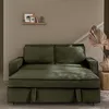 A green sofa bed in a room with a patterned wall and decorative items. Anteprima dell’immagine prodotto